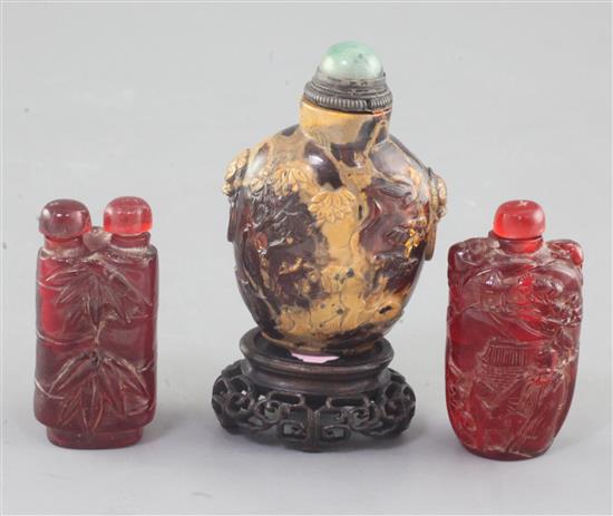 A Chinese amber snuff bottle and two cherry amber snuff bottles, 19th / early 20th century, 6.5cm incl. stopper (3)